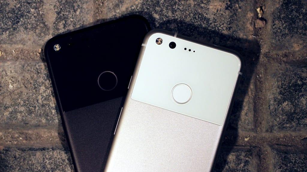 Two Google Pixel smartphones resting on a textured surface