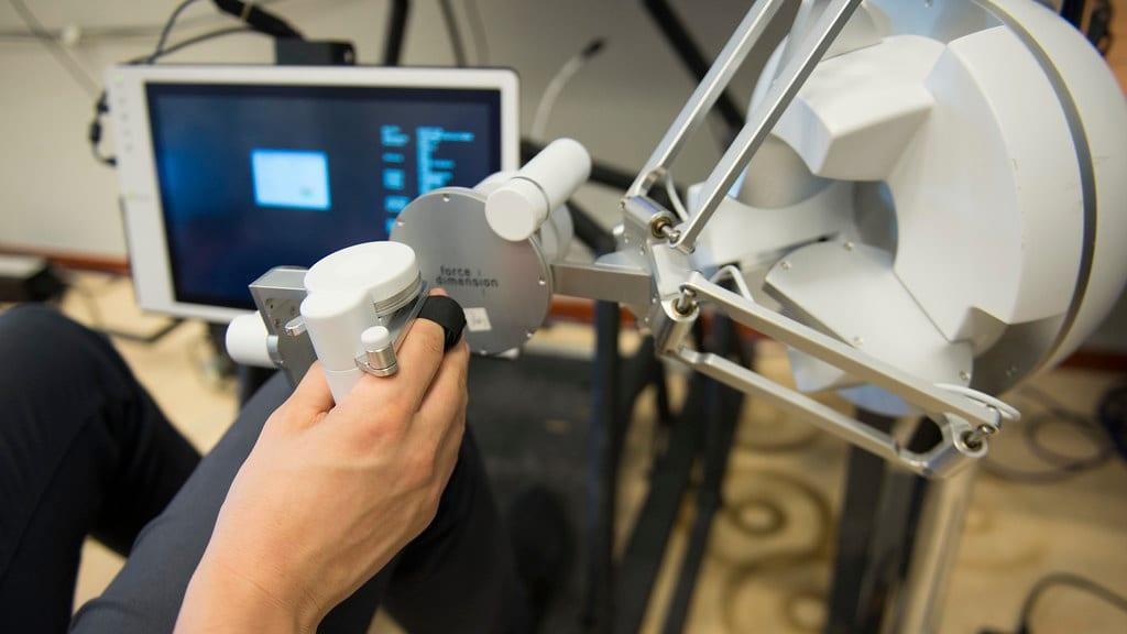 Researchers developed a robot system that actively explores objects to learn their properties